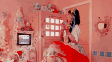 a girl in a red dress is sitting on a bed