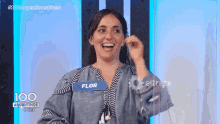 a woman with a name tag that says flor is smiling
