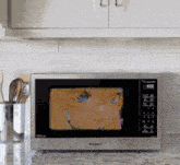 a panasonic microwave shows a picture of a girl