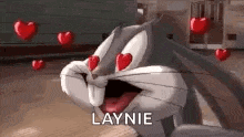 bugs bunny from looney tunes is in love with hearts flying around him .