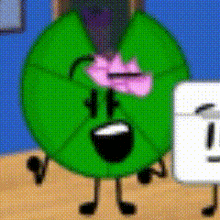 a green cartoon character with a pink bow on its head is standing next to a white object .