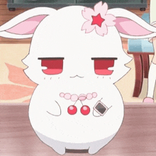 a white rabbit with a flower on its head is sitting on a wooden table .