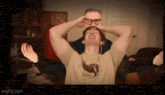 a man wearing a kiwi shirt is being tickled by another man