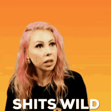 a woman with pink hair is standing in front of a sign that says " shits wild "