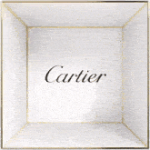 a red and white box with the word cartier written on it .