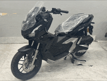 a black scooter with the word adv on the front of it