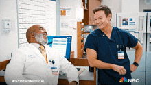 two doctors are laughing in an office with a nbc logo on the bottom