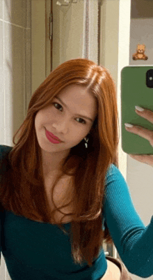 a woman is taking a selfie with her phone