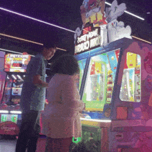 a man and a girl are playing a game with a sign that says angry birds