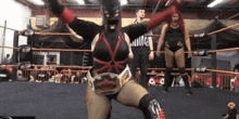 a woman in a wrestling ring is wearing a belt that says " killer "