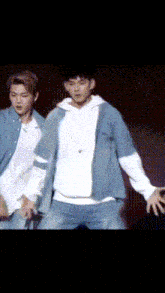a man in a white shirt is dancing on a stage