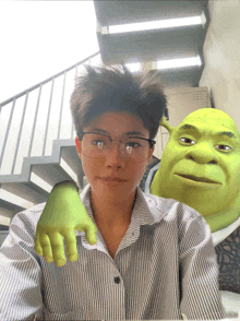 a man wearing glasses and shrek 's hand on his shoulder