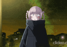 a girl in a black coat stands in front of a cleido.c logo