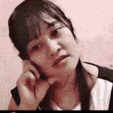 a woman is talking on a cell phone with a sad look on her face .
