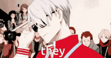 a man in a red jacket is standing in front of a crowd of people and says they