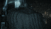 a close up of batman 's face with a dark background