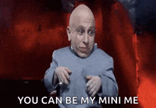 a bald man in a blue suit is pointing at the camera and says you can be my mini me