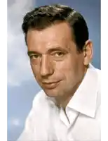 a close up of a man 's face with a white shirt on