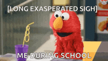 elmo from sesame street is sitting at a table with a purple cup and a straw .