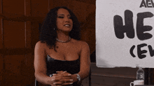 a woman says i 'm so bad that i 'm good in front of a sign