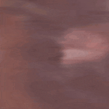 a close up of a man 's face with a beard .