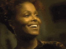 a close up of a woman 's face laughing with her eyes closed