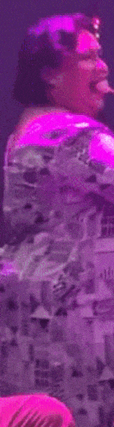 a person is playing a video game while holding a pink object .