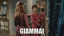 a woman in a red dress is standing in front of a mirror with the word giammai written on the screen