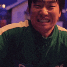 a man in a green outfit is holding a piece of paper