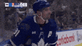 a hockey player with the number 11 on his jersey stands on the ice