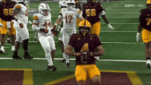a football player in a maroon uniform with the number 4 on it