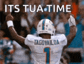 a football player with the name tagovailoa on his jersey is giving the middle finger