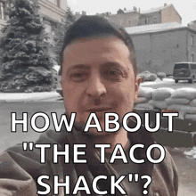 a man is standing in front of a pile of sandbags and says " how about the taco shack "