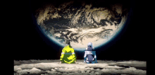 two people sitting on the moon looking at the planet earth