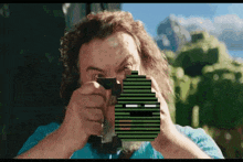 a man with a beard is holding a gun with a pixelated face on it