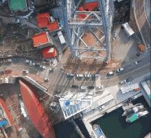 an aerial view of a city with a bridge and a boat