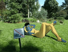 a cartoon character is laying on the grass next to a sign that says no boating