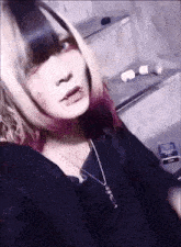 a girl with a necklace and a cigarette in her hand