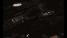 a blurred image of a person holding a gun in a dark room with a red spot in the middle
