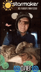 a man is holding a cat in front of a starmaker advertisement
