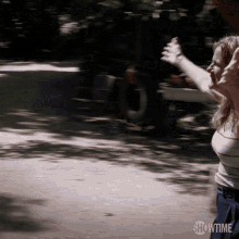 a woman with her arms outstretched in a showtime advertisement