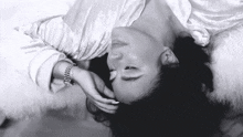 a black and white photo of a woman wearing a bracelet