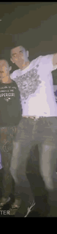 a man wearing a shirt that says special is dancing with another man