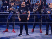 a man in a black shirt that says greatness on a supplement level