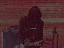 a man playing a guitar with kkitosukki written on the bottom right corner