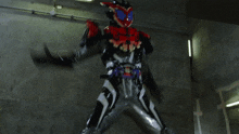 a man in a black and red costume is holding a red sword