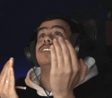 a man wearing headphones is making a face