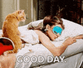 a woman wearing a sleep mask is laying in bed with a cat and the words good day .