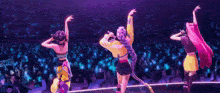 a group of girls are standing on a stage holding microphones .