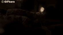 a young boy is sleeping in a bed with a blanket and pillow .